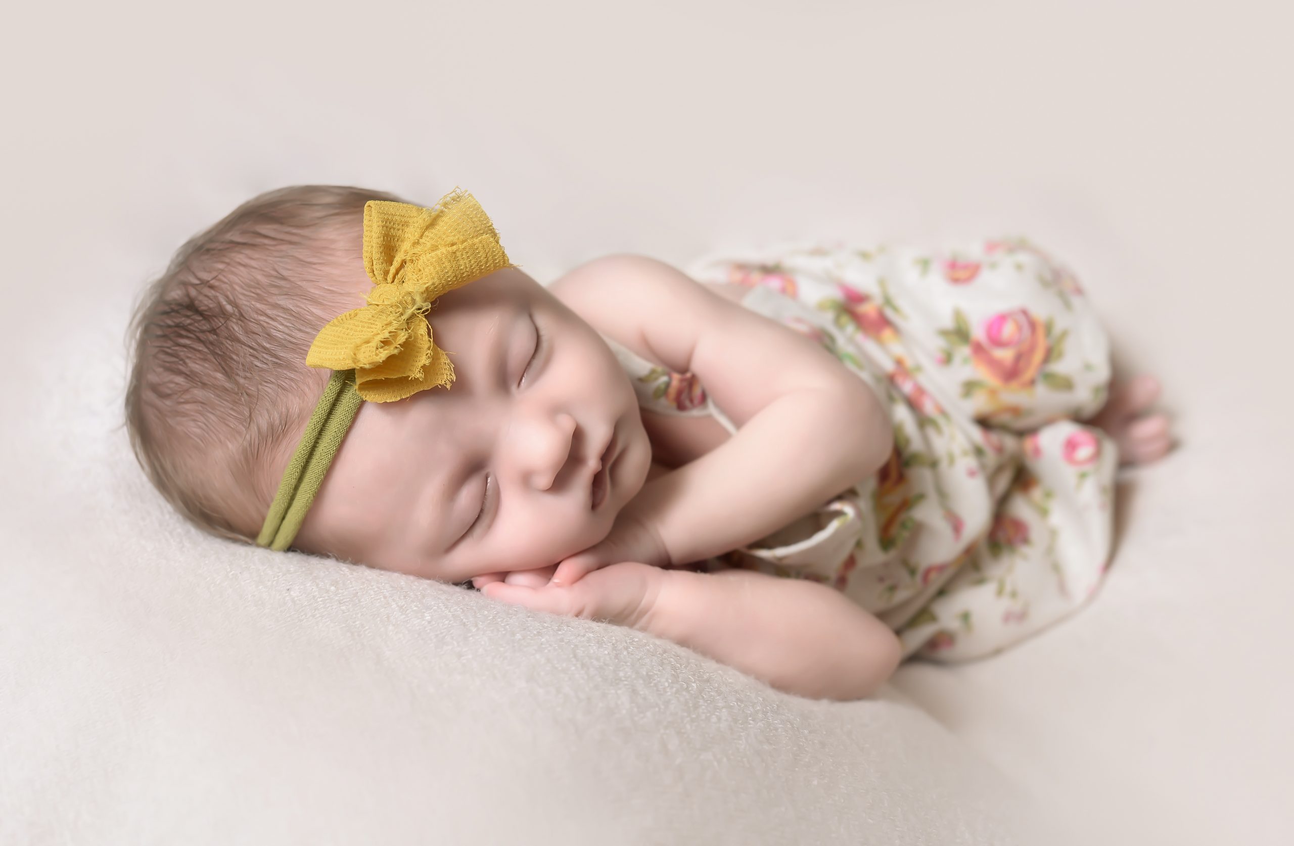 sleeping baby with bow in hair