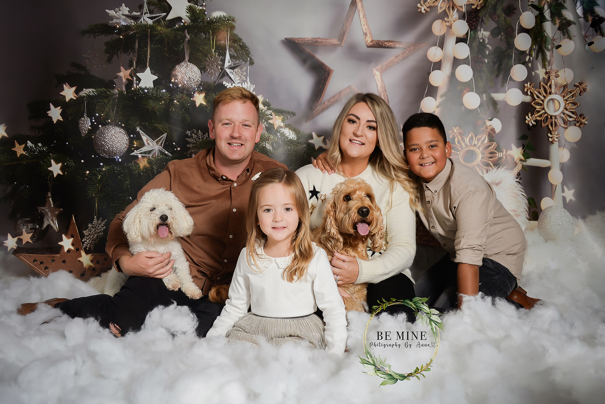 family portrait in front of christmas tree